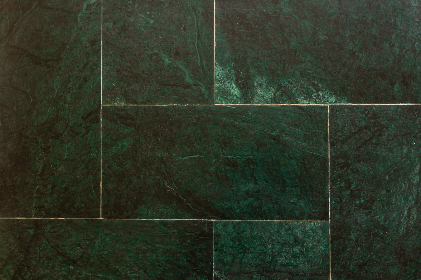 a topdown image of green slate tiling with groute in a home renovation project