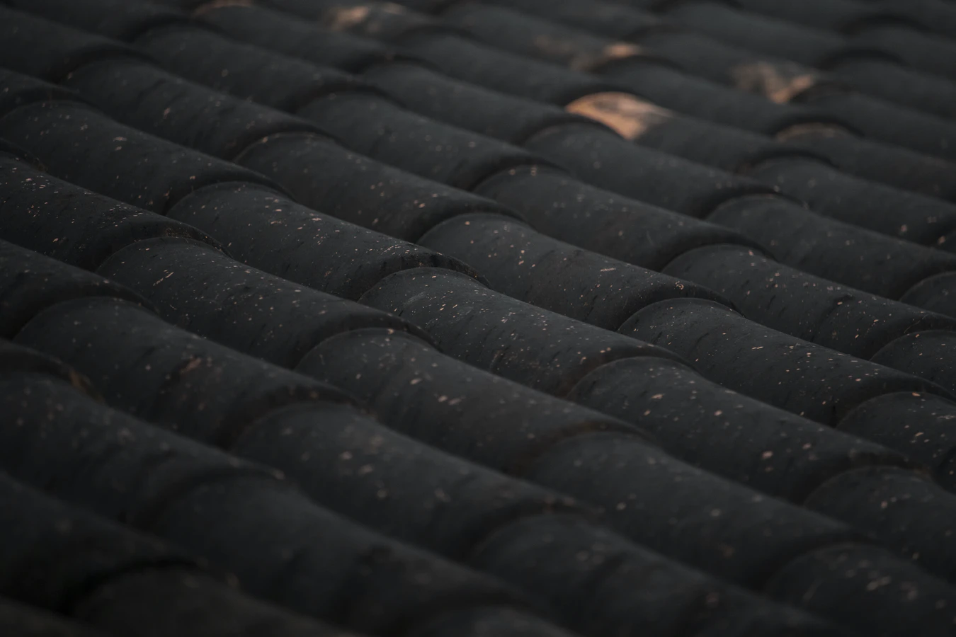 layered black tiles on the roof of a house